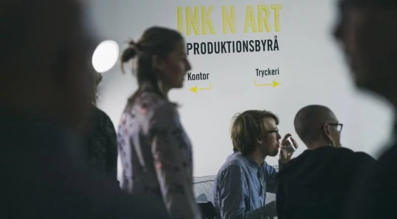 People in front of Ink n Art sign